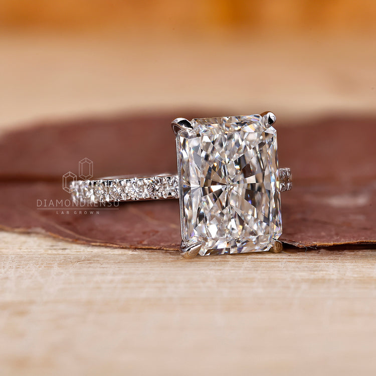 Prong setting holds radiant and round diamonds.
