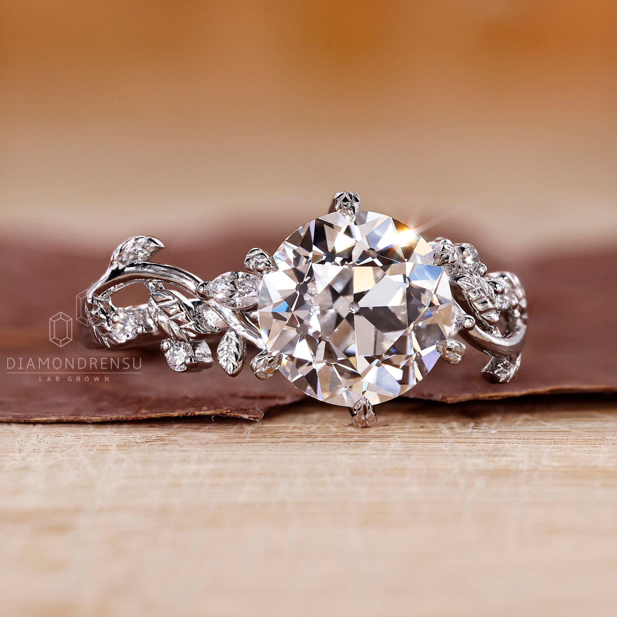 Handmade ring with Old European cut and marquise side stone in white gold.