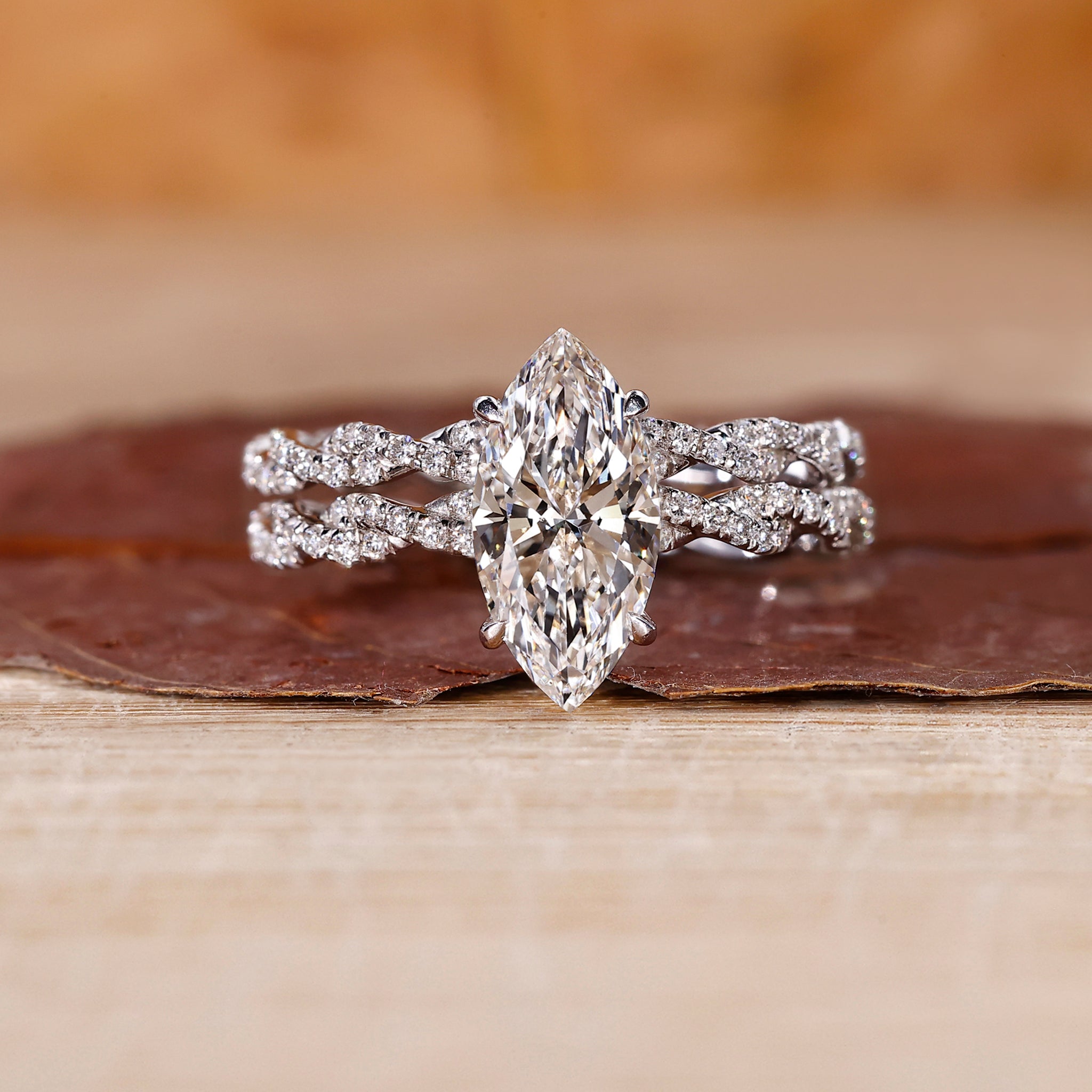Twisted bridal set featuring marquise diamond ring and round cut pave band.