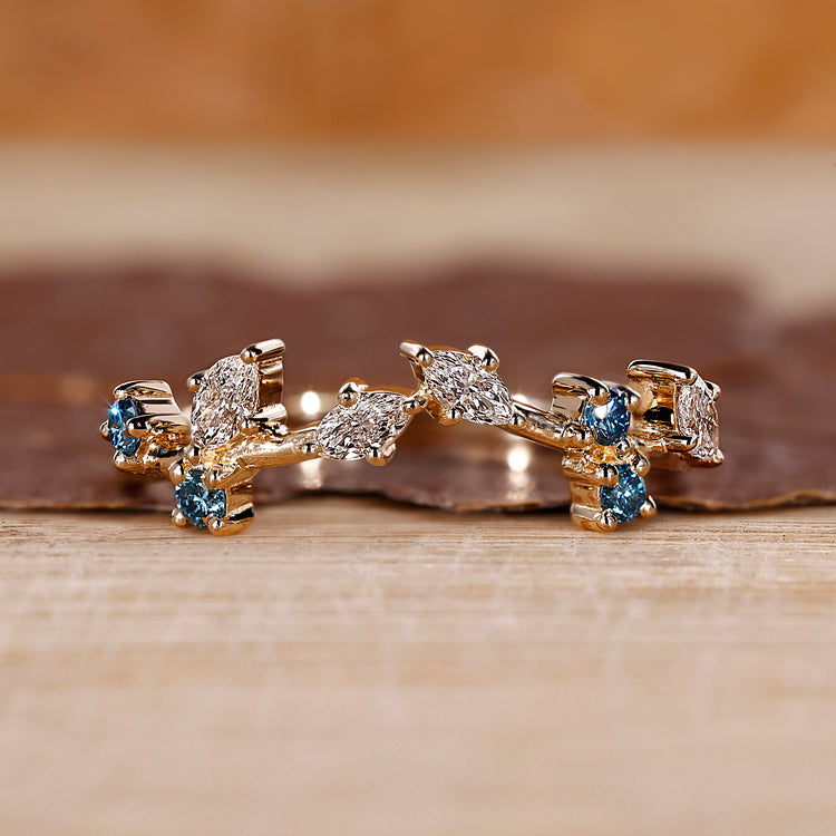 Cluster wedding band with marquise and round diamonds.