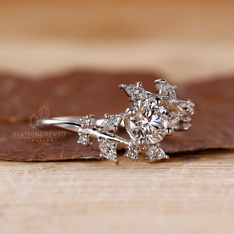 Round and marquise diamond ring in a bypass design.