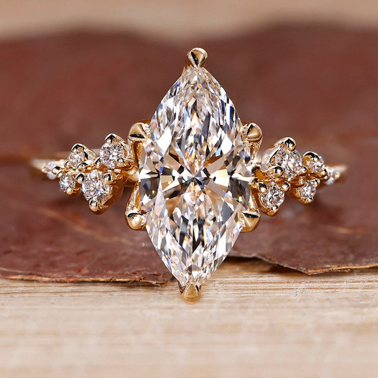 Marquise diamond ring with round cluster style design.