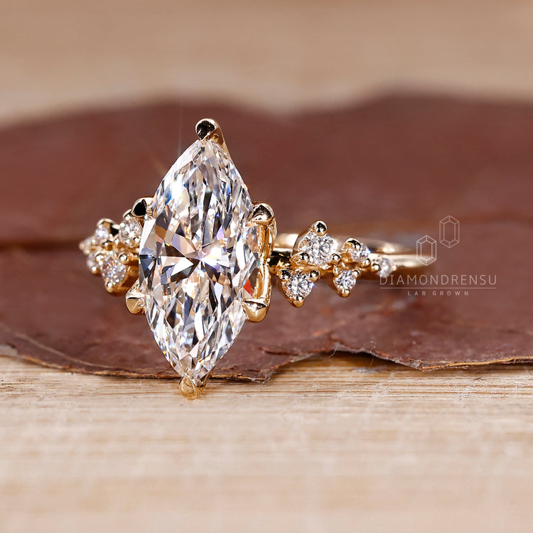 Tulip ring with marquise diamond side stone.