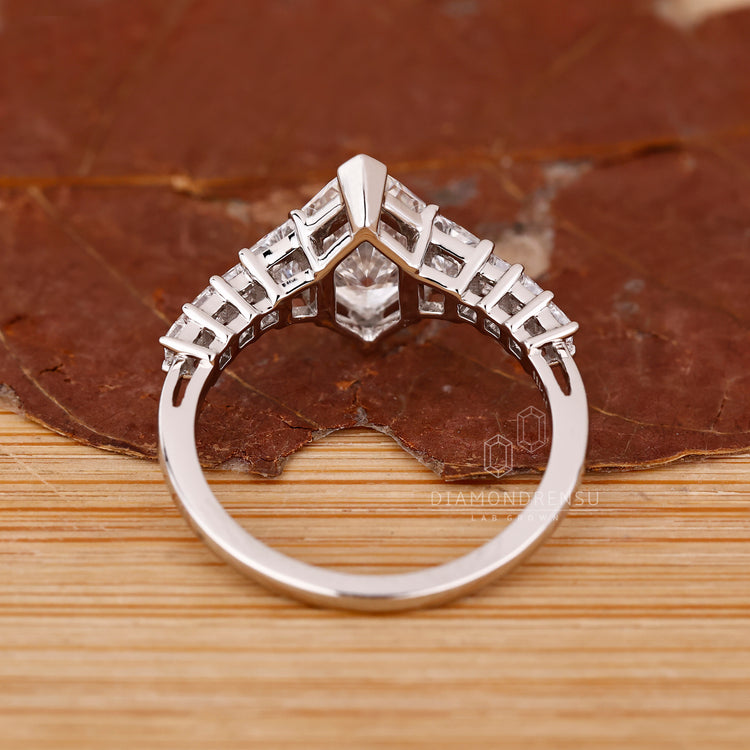 Custom engagement ring with V prong and pave details.