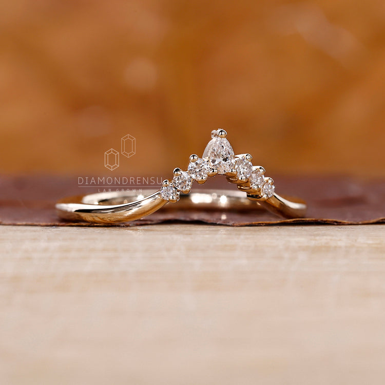 Yellow gold wedding band with seven lab grown diamonds.