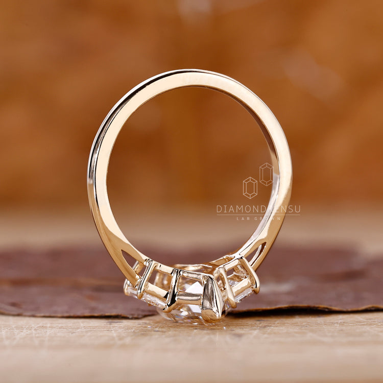 Diamondrensu UK engagement ring with V prong and side diamonds.