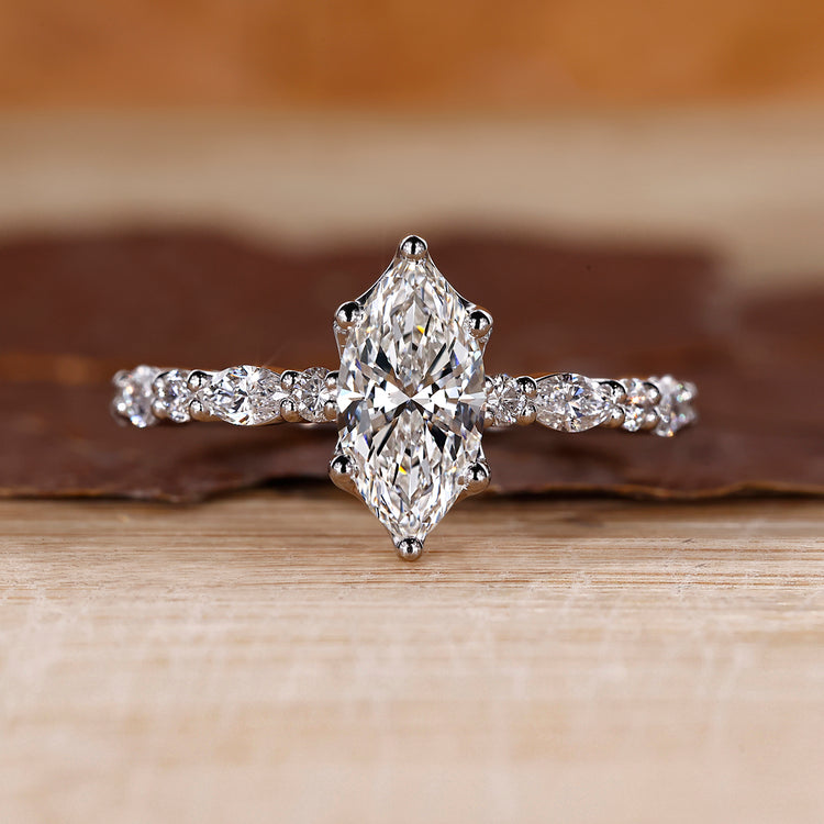 Marquise diamond ring with shared prong setting.