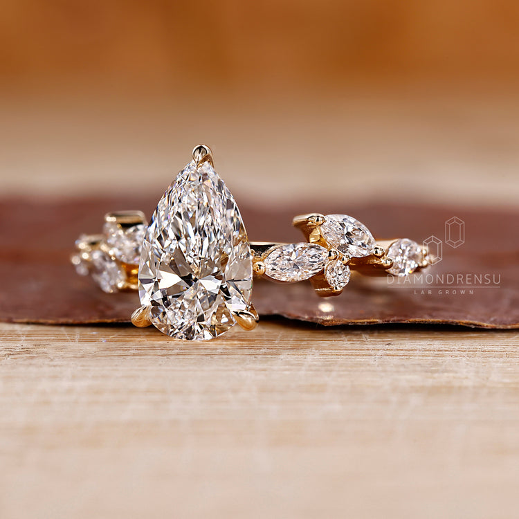 IGI certified pear diamond ring with cluster design.