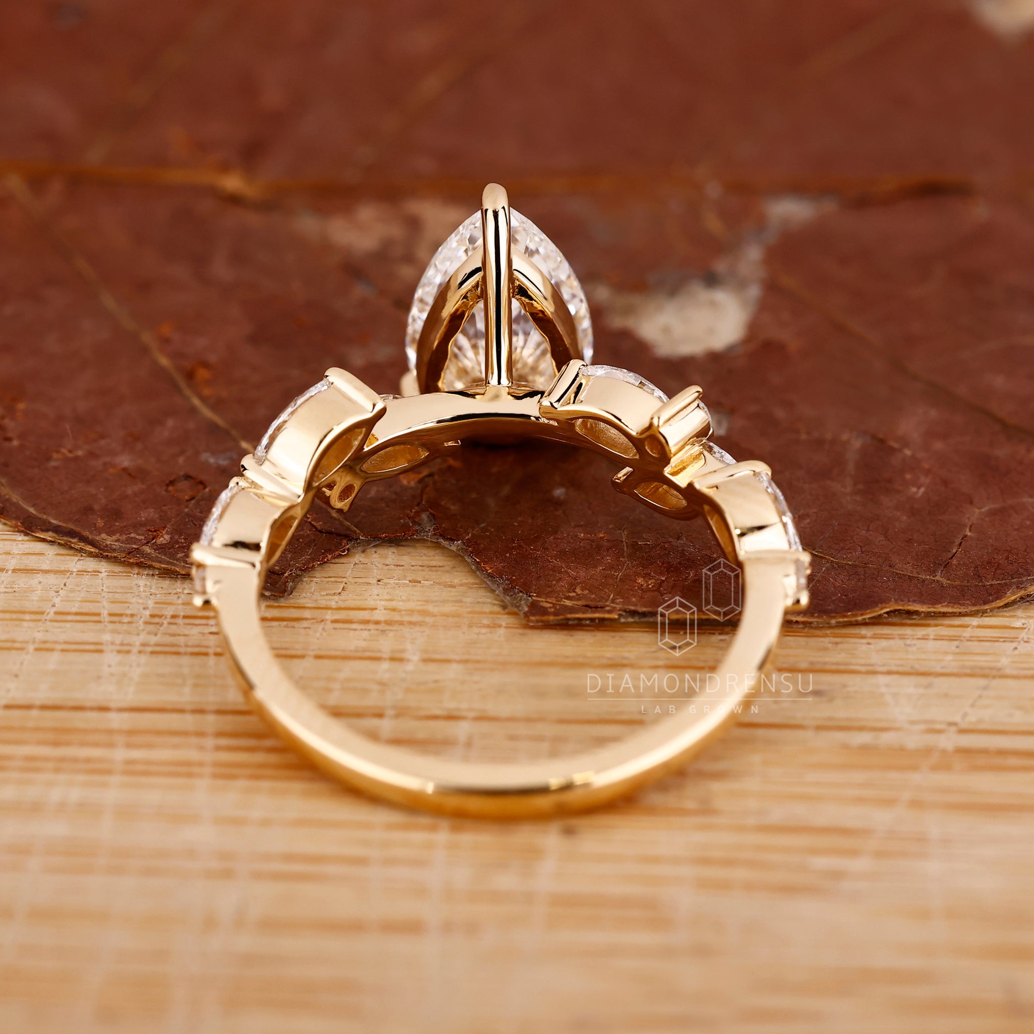 Yellow gold cluster pear shaped diamond engagement ring.