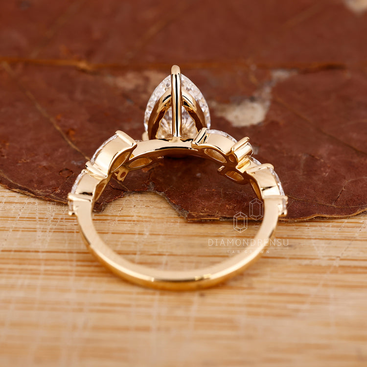 Yellow gold cluster pear shaped diamond engagement ring.