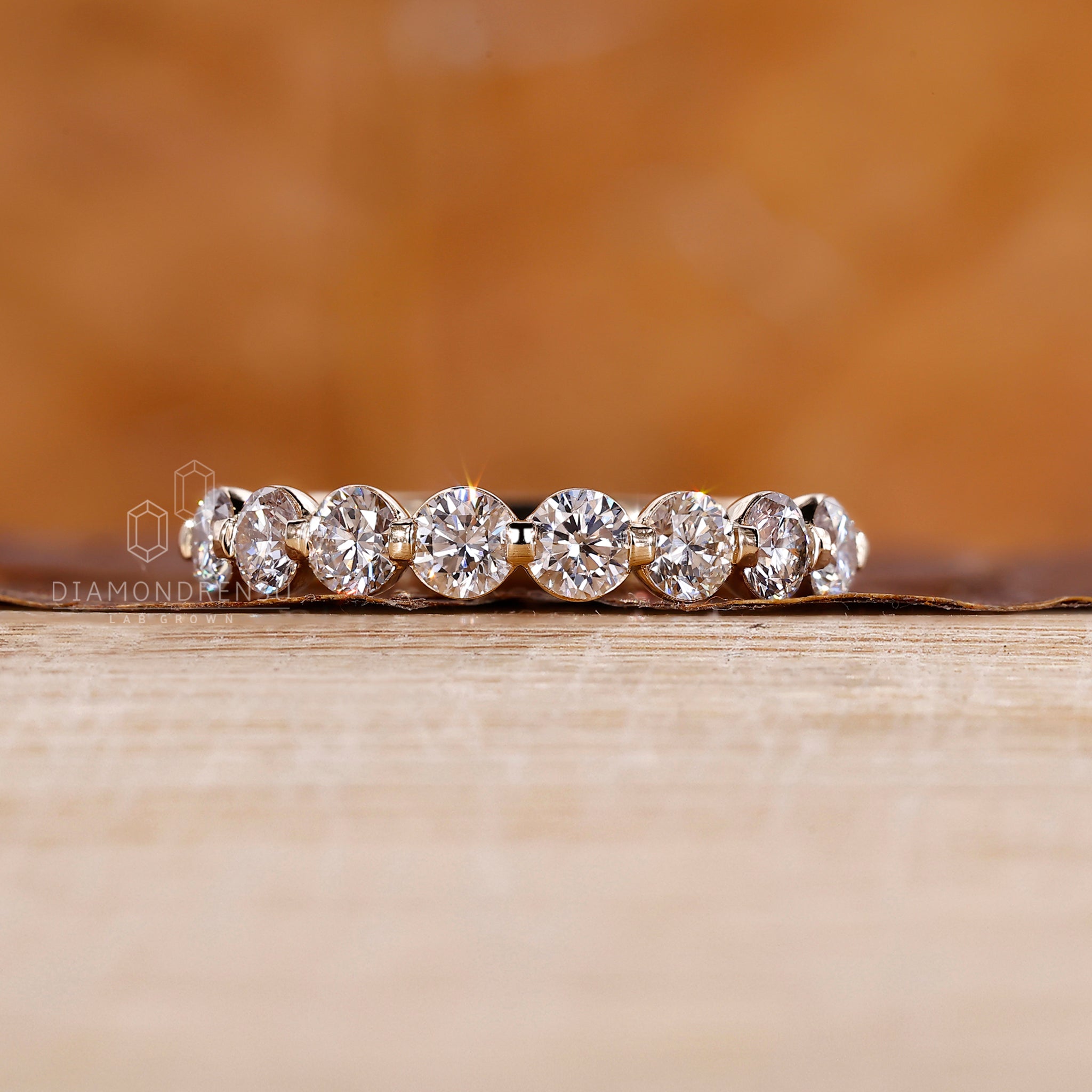 Yellow gold diamond band made with lab grown round cut diamonds.