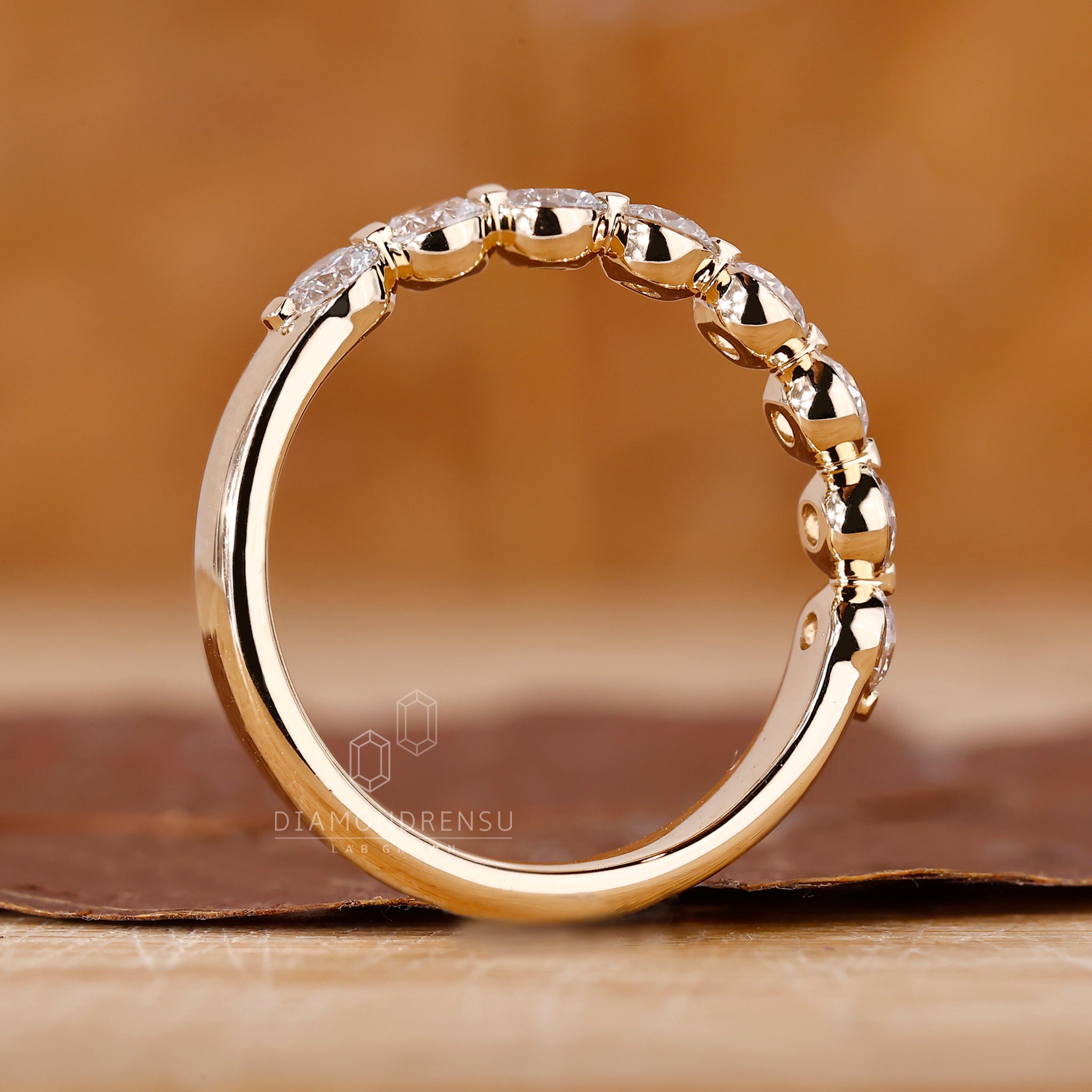 Lab Grown Diamond wedding band in yellow gold with shared prongs.