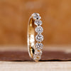 Shared prong diamond band crafted in yellow gold with a sleek design.