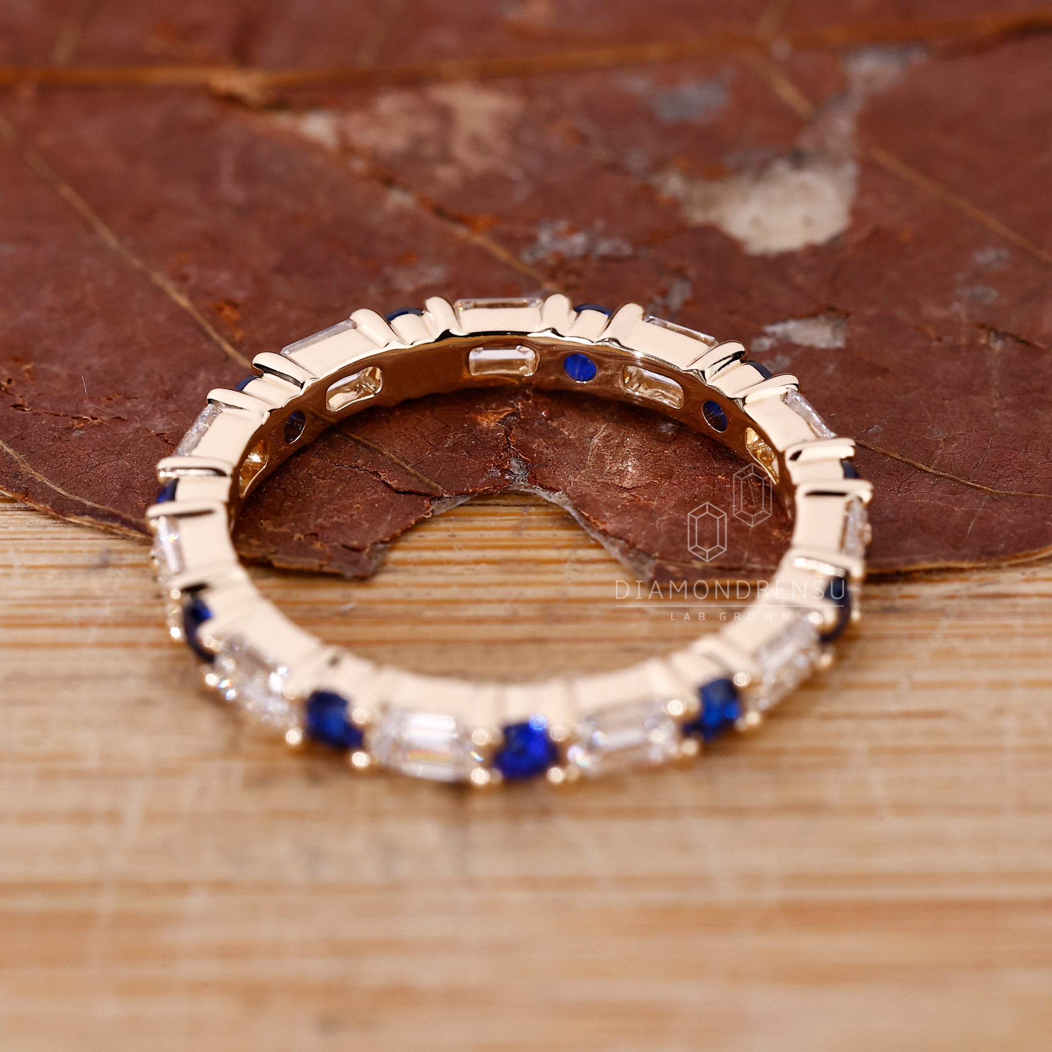 Lab Grown Diamond eternity band with round blue sapphires.