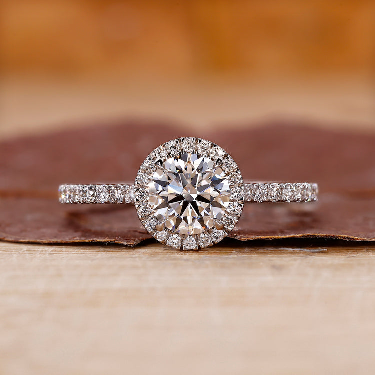 Round cut engagement ring with halo diamond setting.