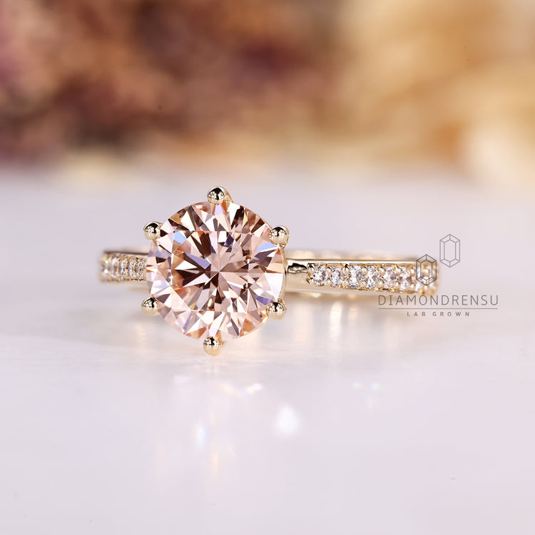 Round cut engagement ring with pave style diamonds.