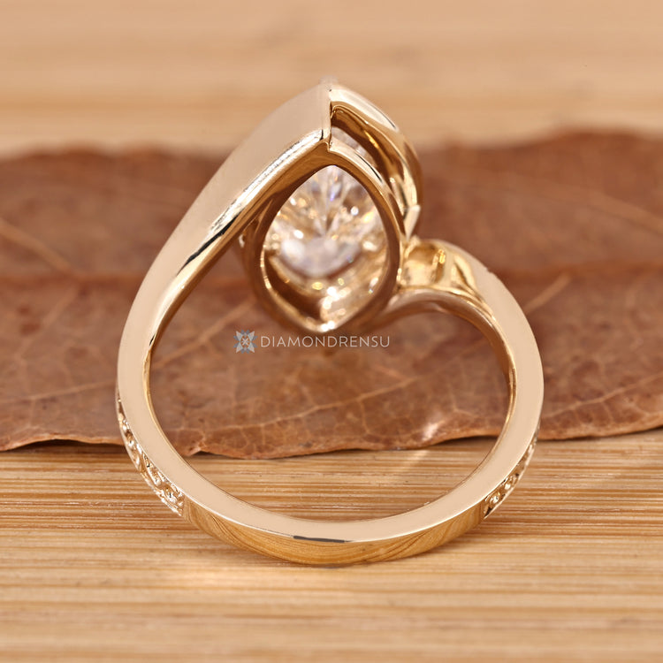 Marquise cut ring with round diamond halo setting.