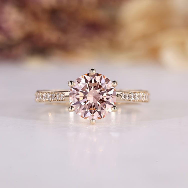 Round cut engagement ring with pink centre diamond.