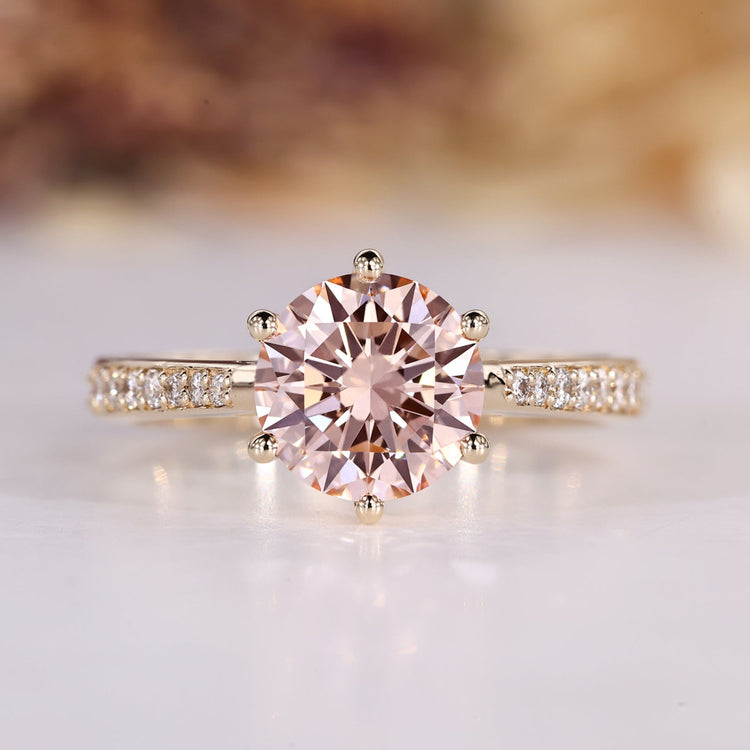 Round cut engagement ring with pink centre diamond.