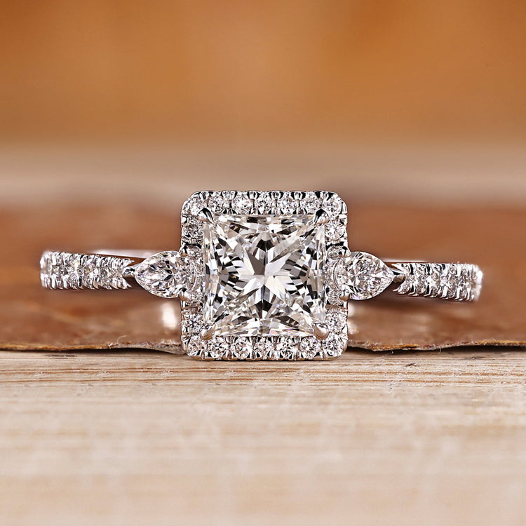 Princess cut diamond ring with round halo diamonds.