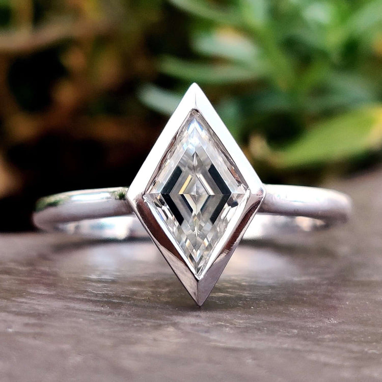 Lozenge shaped solitaire moissanite ring in white gold.