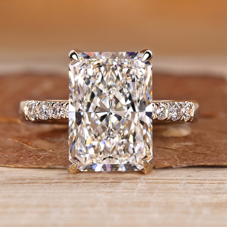 Radiant cut engagement ring with round diamond pave style.