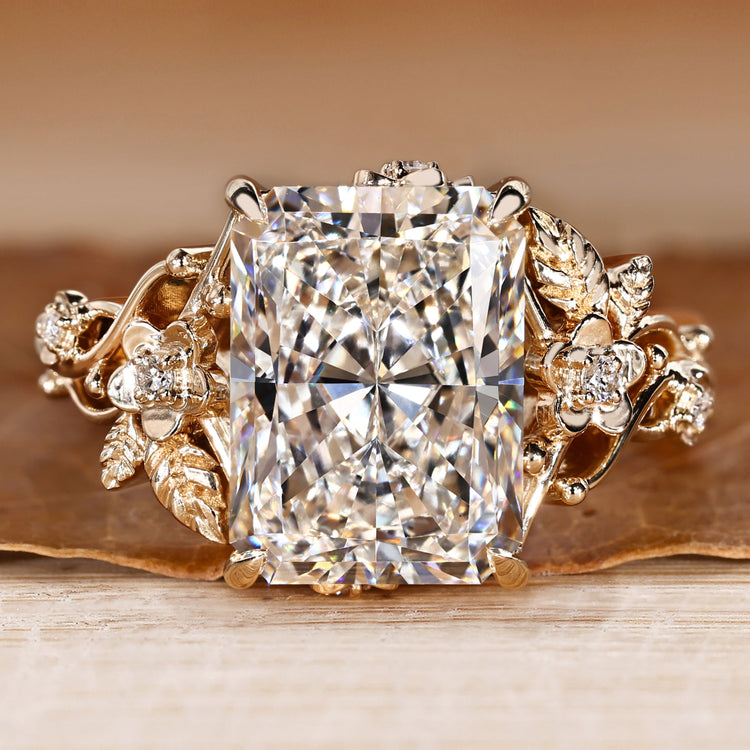 Radiant cut diamond ring with round side stones.
