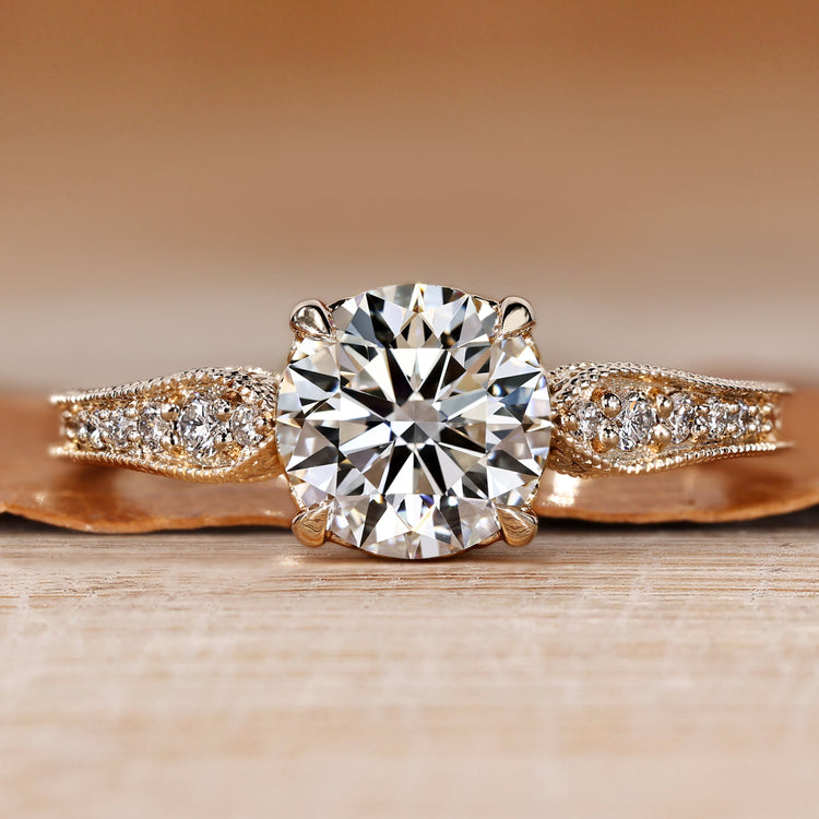 Round cut engagement ring with pavé style and round diamonds.