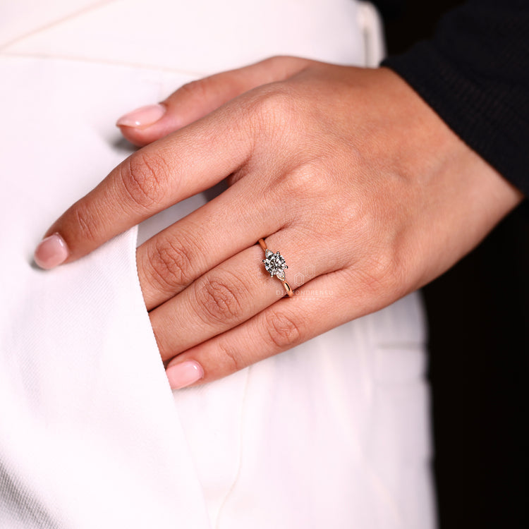 Three stone round diamond ring with cathedral setting.
