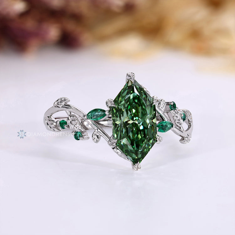 Nature inspired ring with green emerald marquise side stone.