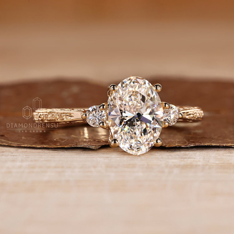 Oval cut diamond ring with round sides and filigree.