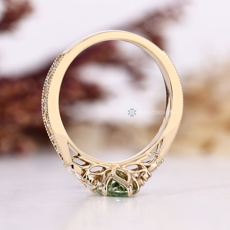 Marquise engagement ring with round side stones and prongs.