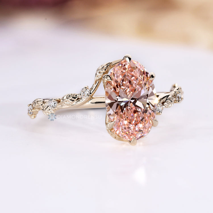 Oval diamond ring with bypass setting and round side stones.