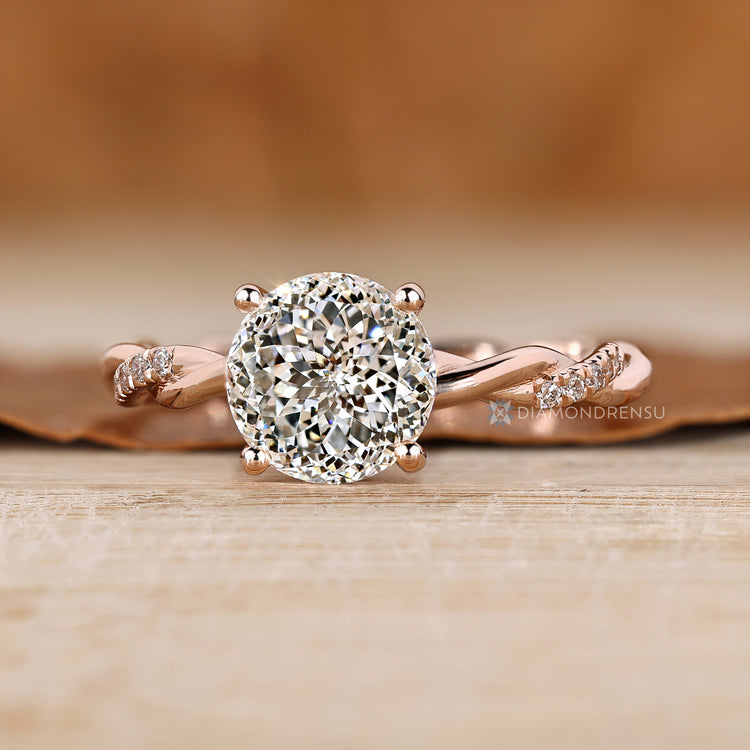 Twisted shank ring with round diamond hidden halo.