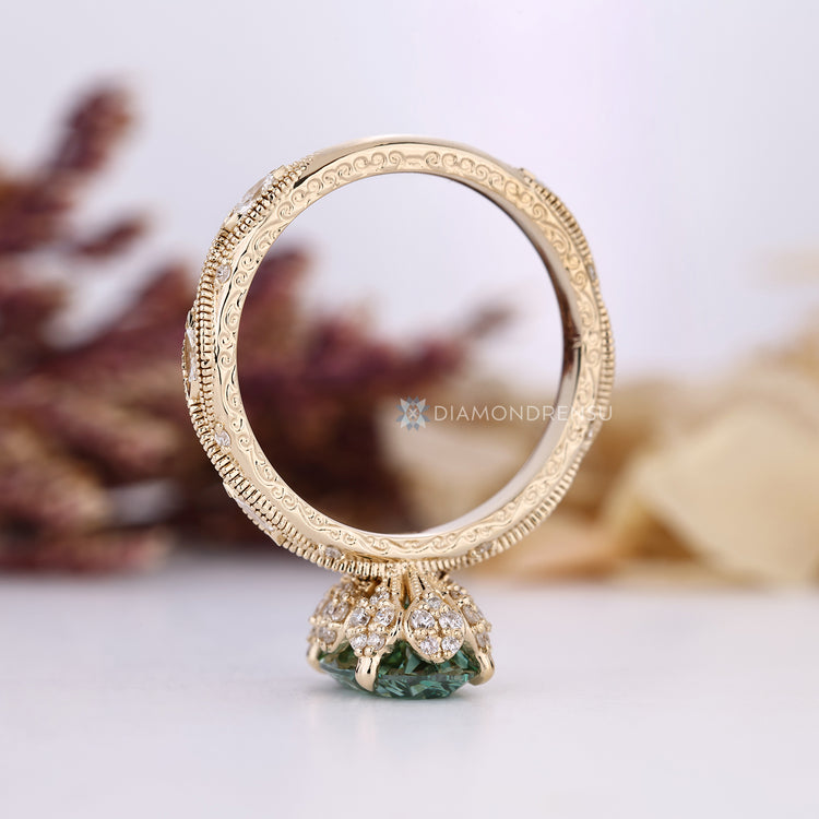 Oval diamond ring with milgrain and marquise side stones.