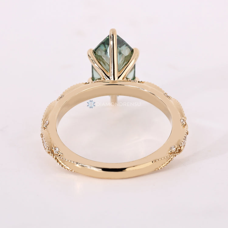 Handmade vintage engagement ring with green diamond.
