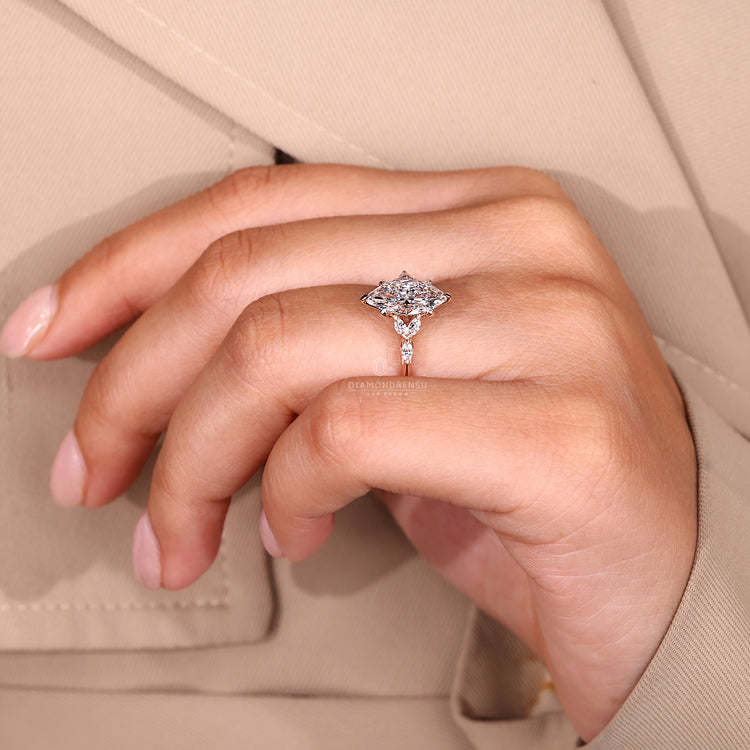 IGI certified marquise ring with side stones and prong.