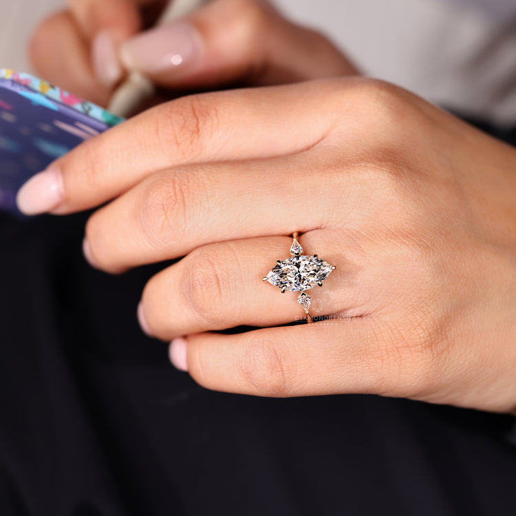 Marquise diamond ring with round cut hidden halo setting.