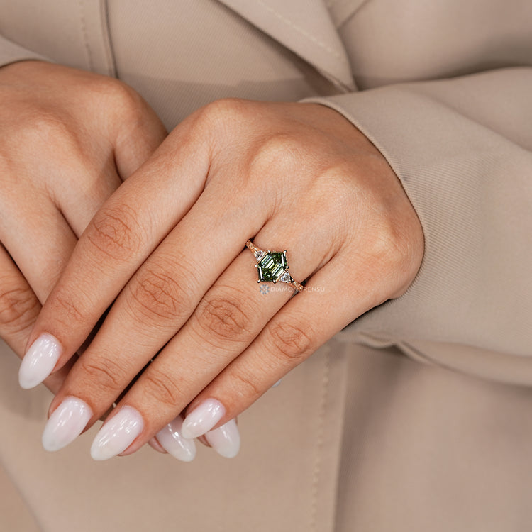 Green centre diamond ring with six claw prong setting.