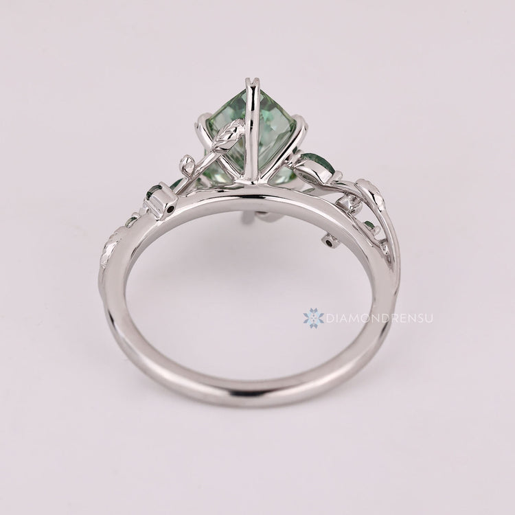 Lab grown marquise diamond ring with moss agate sides.
