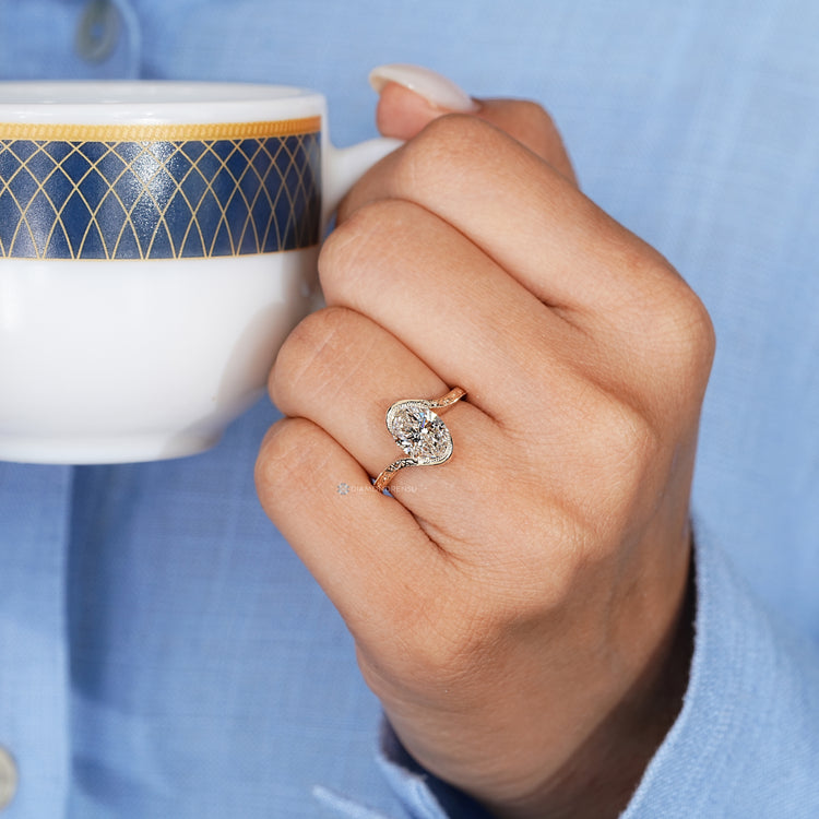 Handmade oval diamond ring with milgrain details.