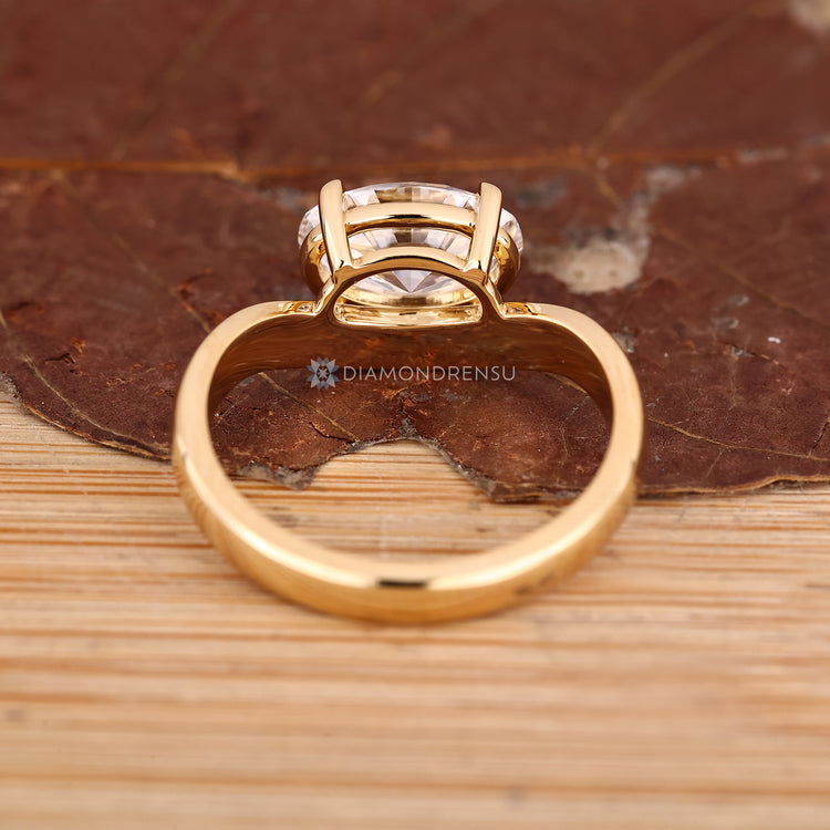 East to west oval diamond ring with basket setting.