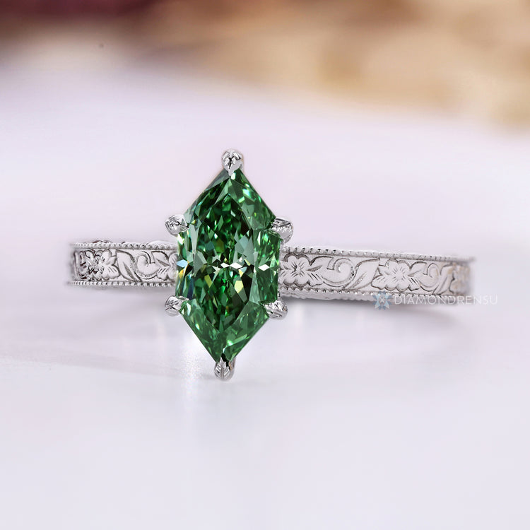Green diamond ring with milgrain details and engraved shank.