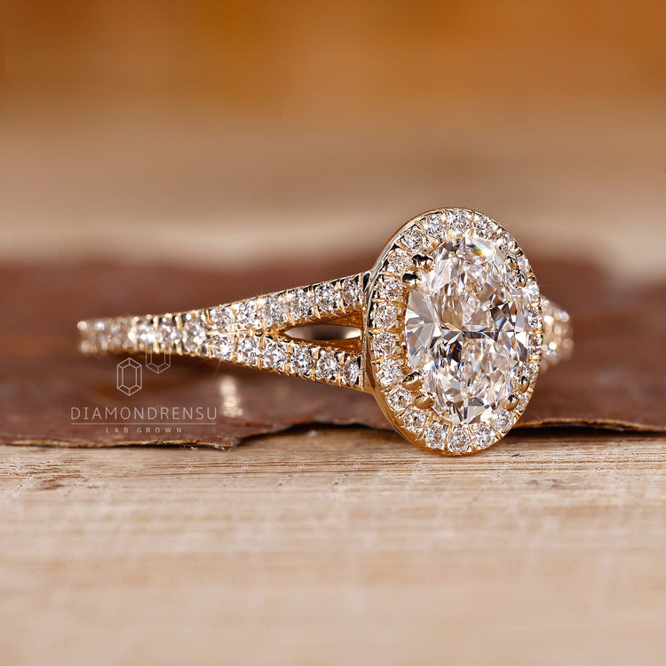 Oval engagement ring with round halo and bridge accents.