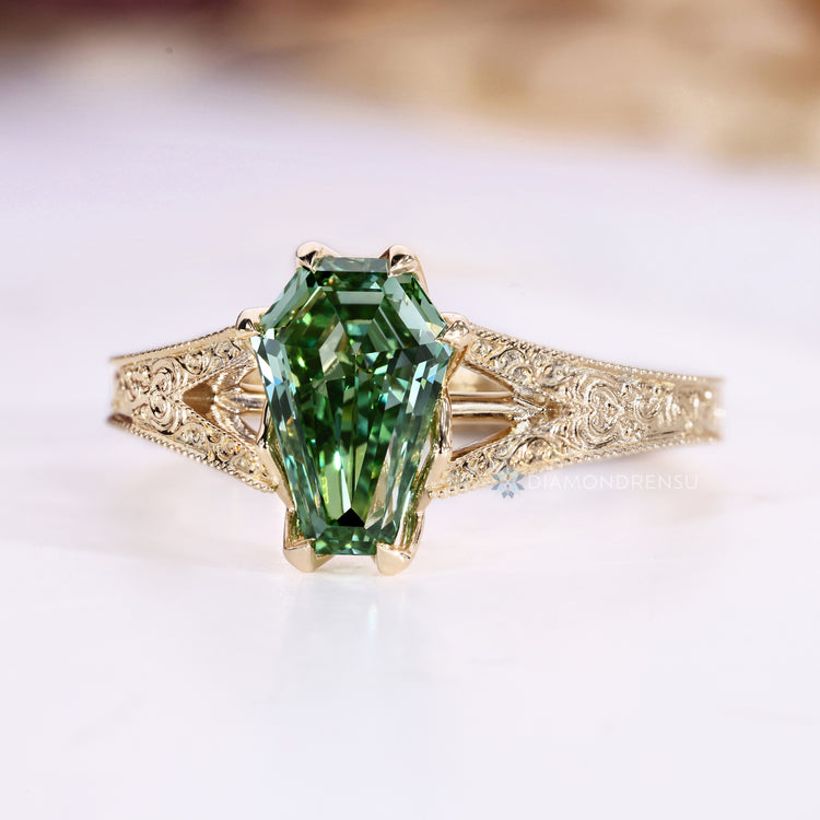Green diamond engagement ring with milgrain details.
