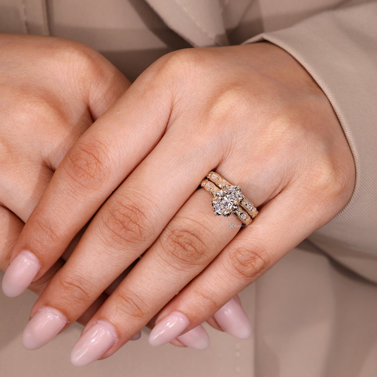 Milgrain details on oval diamond ring and wedding band.