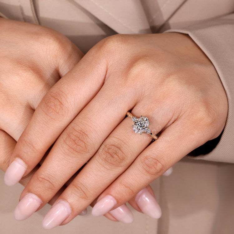 Three stone oval diamond ring with round side stones.