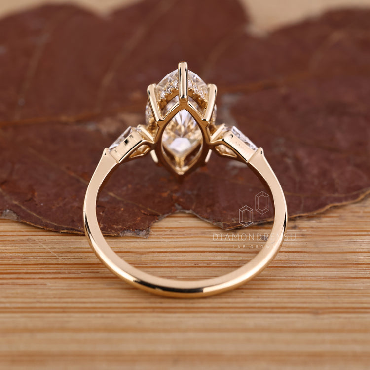 Marquise cut ring with round halo and side stones.