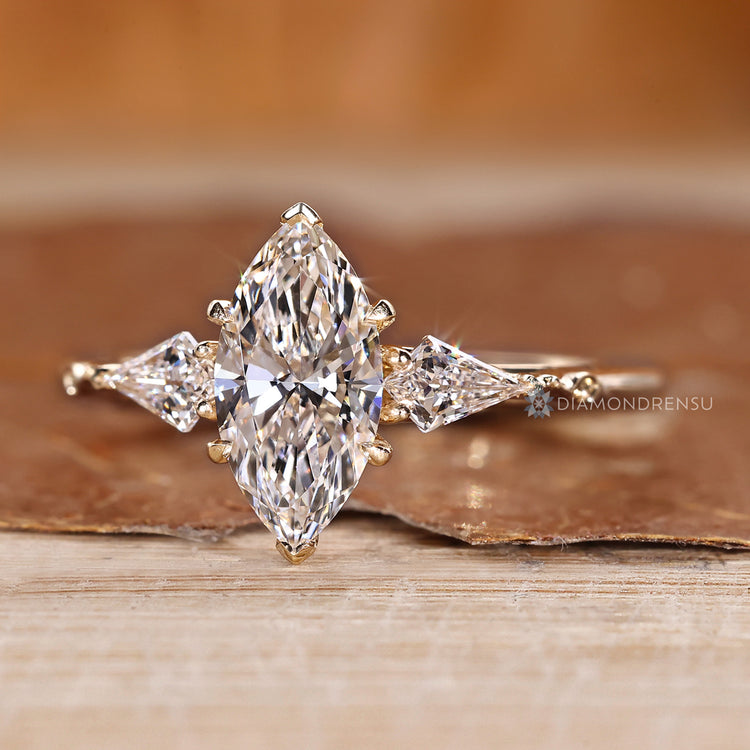 Art deco marquise ring with kite side stone.
