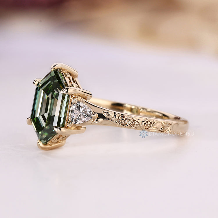 Lab grown green diamond ring with trillion side stones.